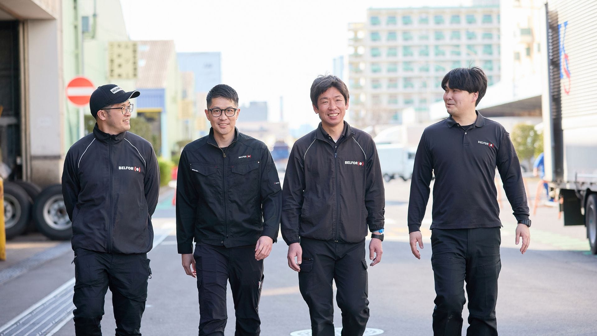 belfor technicians walking side by side on a street, displaying confidence and teamwork