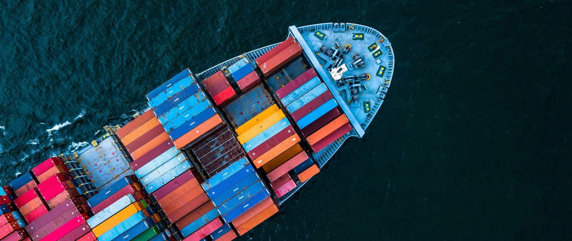 Image of a containership on the ocean from the top-down view