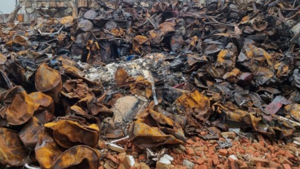 A disordered pile of scrap metal among debris from construction or demolition.