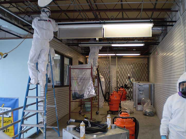 BELFOR team removes asbestos from ceiling