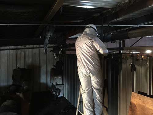 BELFOR technician cleans soot and smoke damage