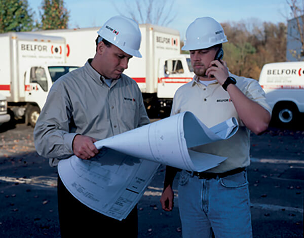 BELFOR general contractors review blueprints