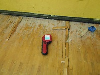 Gymnasium floor water damage before restoration