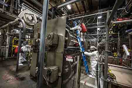 BELFOR technicians decontaminate plant machinery