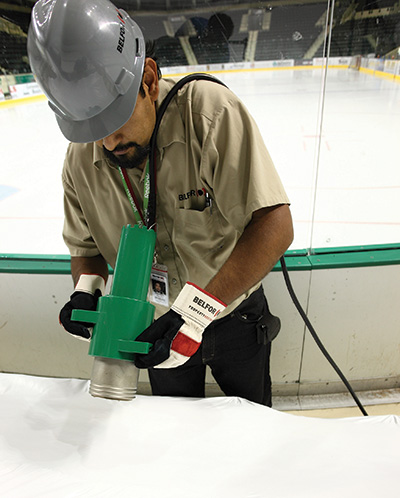 BELFOR technicians uses heat to shrink wrap stadium seats