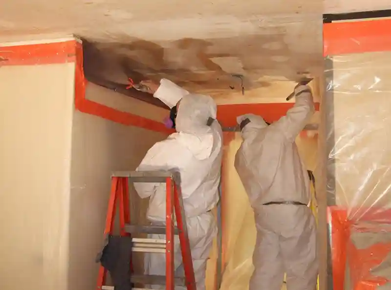 BELFOR workers clean toxic ceiling