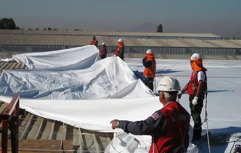 preparing to shrink wrap a roof