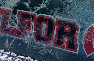 Frosted over car window with a BELFOR Sticker on it