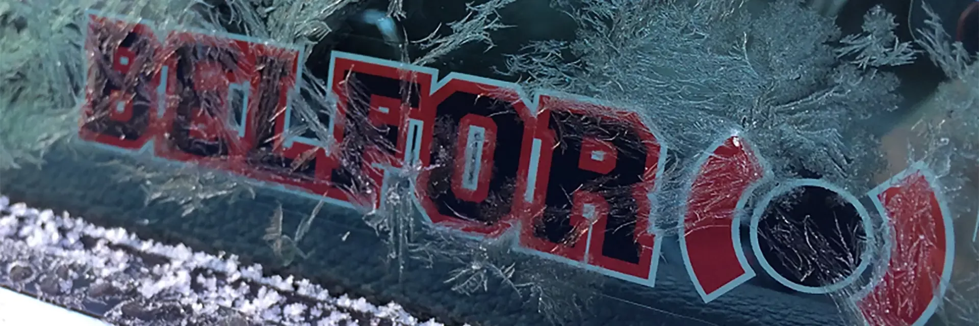 Frosted over car window with a BELFOR Sticker on it