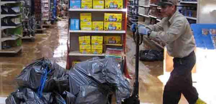 BELFOR technician removing wet contents from flooded store