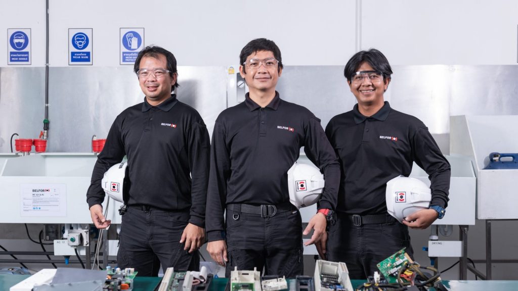 belfor-technicians-standing-infront-of-a-table-of-electronic-components-in-a-modern-workshop