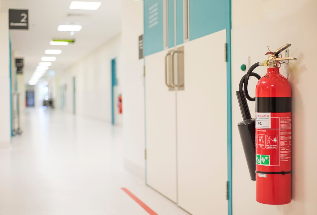 Fire extinguisher mounted on wall in hospital