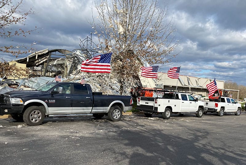 Trucks outside of a tornado damaged high school